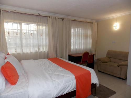 Postel nebo postele na pokoji v ubytování Axis Guest House