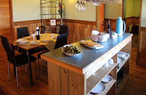 a kitchen with a table with a bowl of food on it at Hotel Rucaitue in Osorno