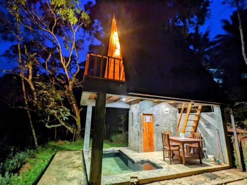a tiny house with a tower on top of it at The Los t paradise - Rambukewela in Deldeniya