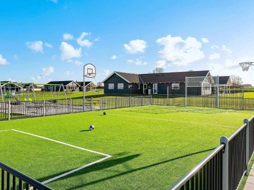 a tennis court with a ball on the court at 5 star holiday home in Bogense in Bogense