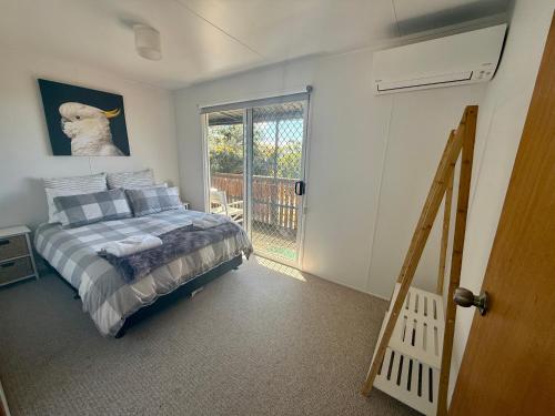a bedroom with a bed and a sliding glass door at The Archer Retreat in Villeneuve