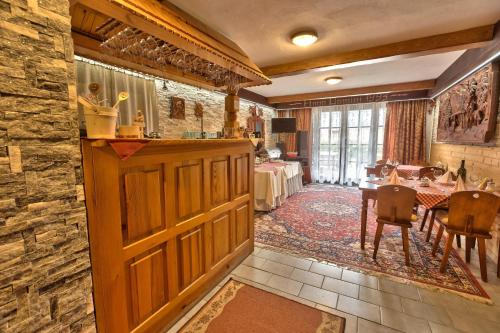 a room with a wooden door and a dining room at Penzion Havran in Ždiar