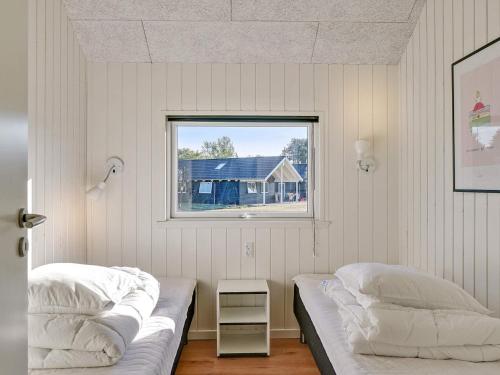 a bedroom with two beds and a window at 14 person holiday home in Vejby in Vejby