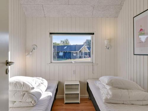 a bedroom with two beds and a window at 14 person holiday home in Vejby in Vejby