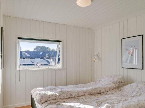 two beds in a room with a window at 14 person holiday home in Vejby in Vejby