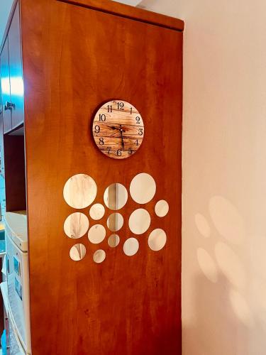 a clock on the side of a wooden door at Lovely Apartment Lamia in Lamía