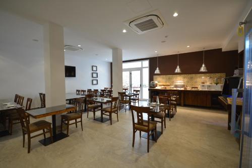 a dining room with tables and chairs and a bar at Palazzo Violetta in Sliema