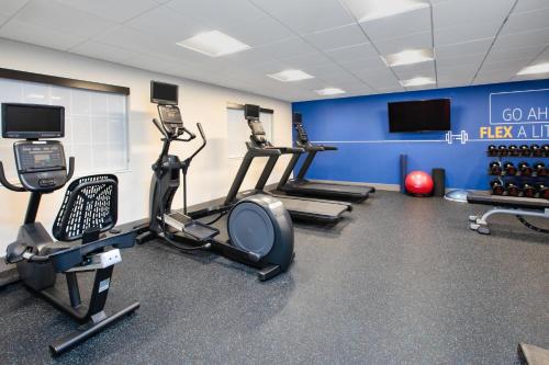 a gym with treadmills and cardio equipment in a room at Holiday Inn Express Hotel & Suites Defiance by IHG in Defiance