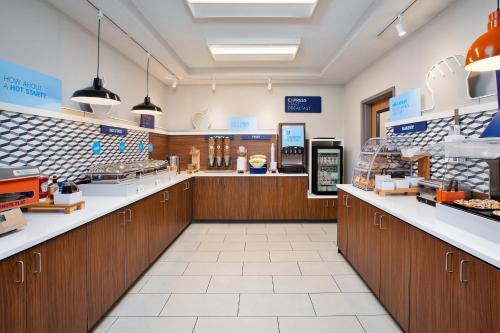 a store with wooden cabinets and counters in a store at Holiday Inn Express Hotel & Suites Defiance by IHG in Defiance