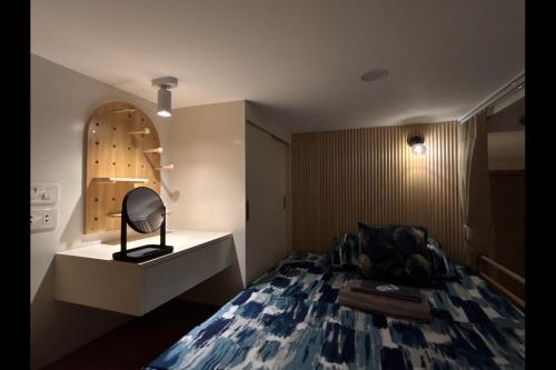 a bedroom with a bed and a desk with a lamp at Iloilo Condo for Group Stay in Iloilo City