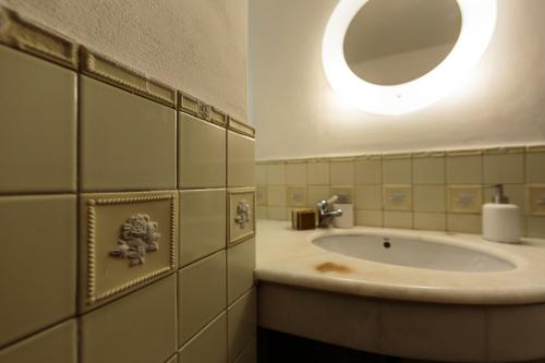 a bathroom with a sink and a mirror at Alla dimora di Chiara Suite and Rooms in Matera