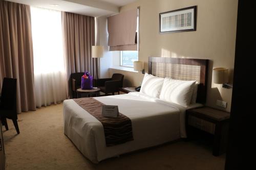 a hotel room with a bed and a window at Hotel Felda Residence Kuala Terengganu in Kuala Terengganu