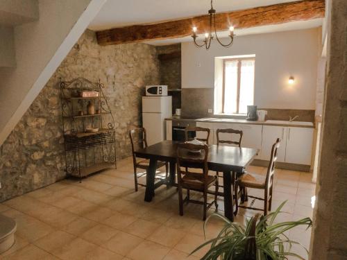 a kitchen and dining room with a table and chairs at Holiday Home in Montbrun with Pool & Vineyards in Montbrun-des-Corbières