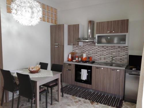 a kitchen with a table and a stove top oven at Casa Giorgia in Cefalù