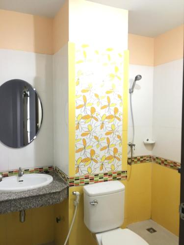 a bathroom with a toilet and a sink and a mirror at The Star Villa Resort in Hat Yai