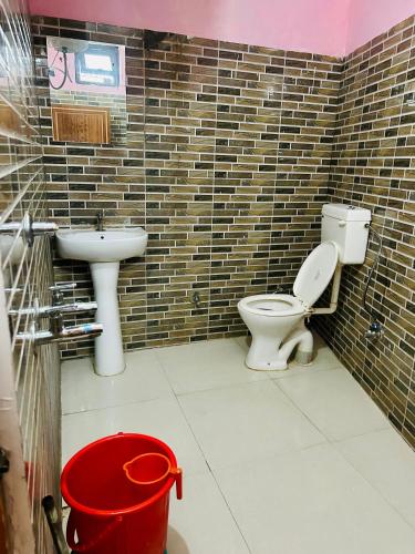 a bathroom with a toilet and a sink at Green Valley Hotel in Lansdowne