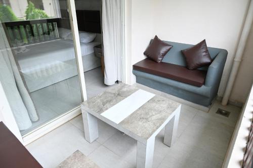 a living room with a couch and a table at Sia Signature Calangute in Calangute