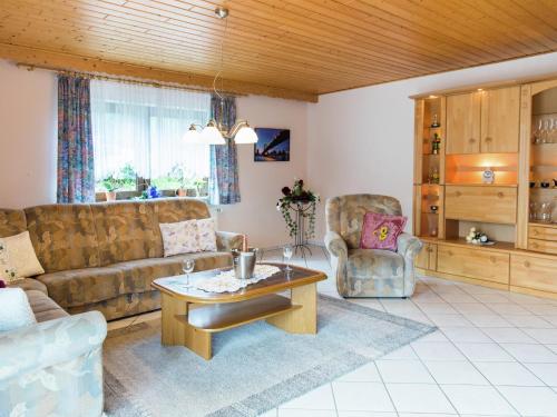 a living room with a couch and a table and chairs at Tranquil Eifel Hideaway in Lirstal