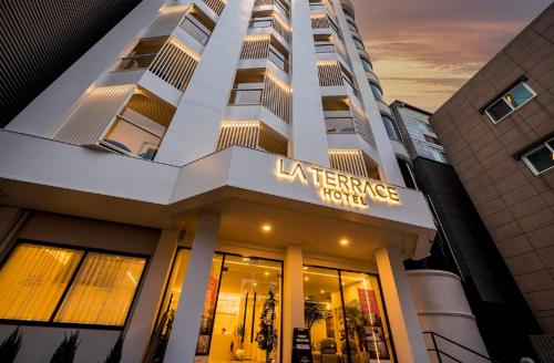 a large building with a sign on the front of a store at Pohang Hotel La Terrace in Pohang