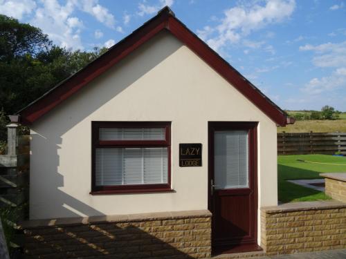 a small house with a sign that reads mph at Lazy Lodge in Foxdale