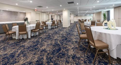 a banquet room with tables and chairs and a podium at Holiday Inn New Orleans-Downtown Superdome by IHG in New Orleans