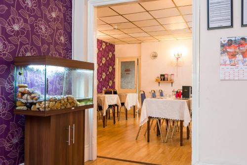 a dining room with a fish tank and a dining table at UK Travel & Hospitality LTD TA Canberra Hotel in Blackpool