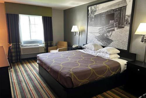 a hotel room with a large bed and a window at Super 8 by Wyndham Mound City in Mound City