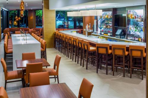 a restaurant with tables and chairs and a bar at Hyatt House Seattle Downtown in Seattle