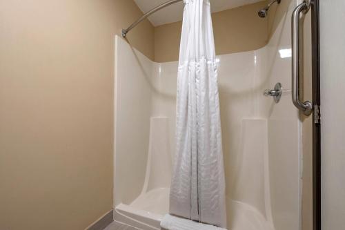 a shower with a white shower curtain in a bathroom at Comfort Inn Romeoville - Bolingbrook in Romeoville