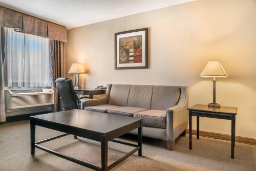 a living room with a couch and a coffee table at Quality Inn & Suites Next to the Casino in Ceresco