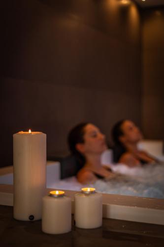 two women in a bath tub with candles at Ludwig Boutique Hotel & Spa in Bolsena