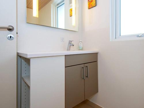 a bathroom with a sink and a mirror at Luxury Pool Retreat in Henne - By Traum Ferienwohnungen in Henne Strand