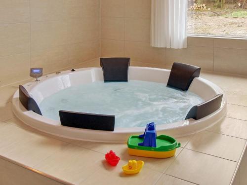 a jacuzzi tub with chairs and a toy in it at Luxury Pool Retreat in Henne - By Traum Ferienwohnungen in Henne Strand