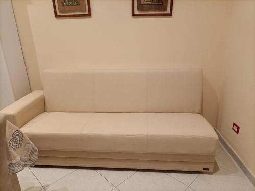 a white bed in a corner of a room at La Fenice in Mola di Bari