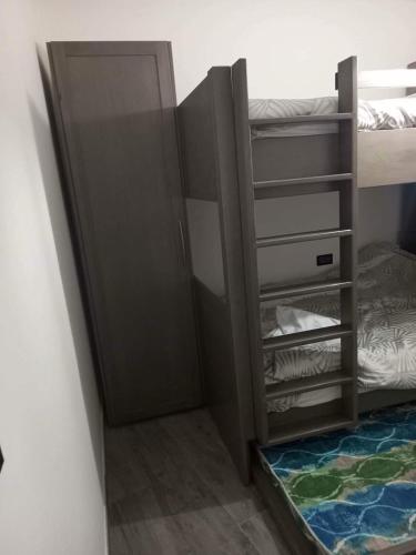a room with a bunk bed and a closet at The Island Crib in Sannat