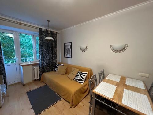 a bedroom with a bed and a table in it at Three Bedroom Stepana Bandery Street in Rivne