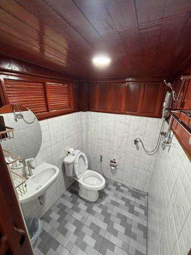 a small bathroom with a toilet and a sink at Guitar Thai Style Pool House in Ao Nang Beach