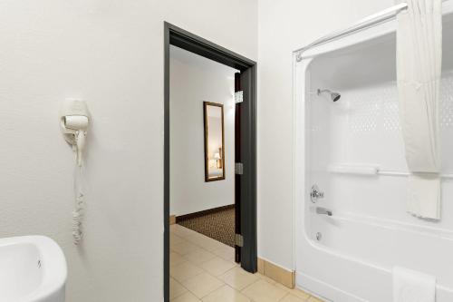 a bathroom with a shower and a toilet and a sink at Quality Inn & Suites McAlester on Hwy 69 in McAlester