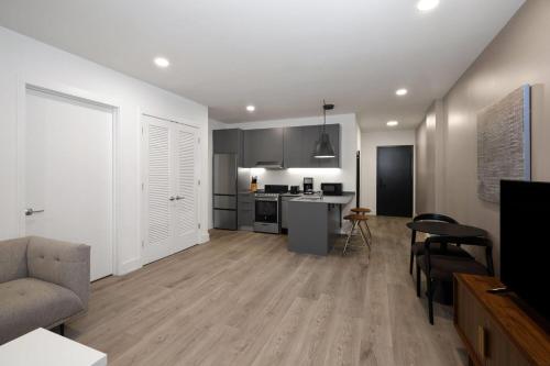 a kitchen and living room with a couch and a table at Reside NoMa, a Wyndham Residence in Washington