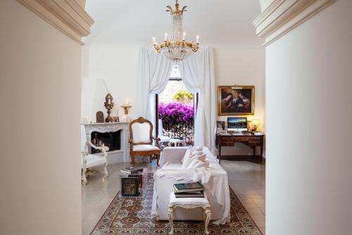 a living room with a bed and a chandelier at Hotel Villa Taormina in Taormina