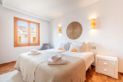 a bedroom with two towels on a bed at Voramar Alcudia in Alcudia