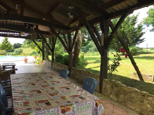 a table and chairs under a pergola at Cozy French Escape in Monfort in Monfort