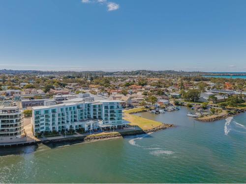 an aerial view of a hotel and a body of water at The Top Deck Retreat Ballina in Ballina