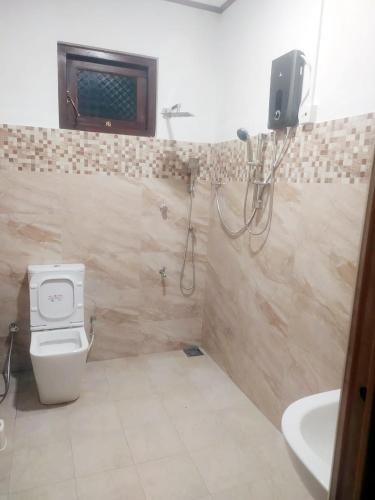 a bathroom with a shower and a toilet and a sink at Misty Morning Villa Ella in Ella