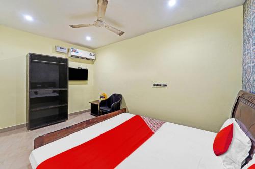a bedroom with a bed and a flat screen tv at Hotel O Le Serenity Beach View Resort in Kottakupam