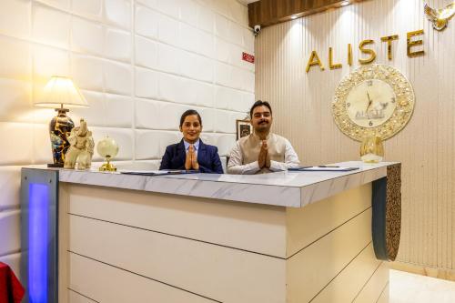 a man and a woman sitting at a desk at Aliste Millennium Huda City Centre in Gurgaon