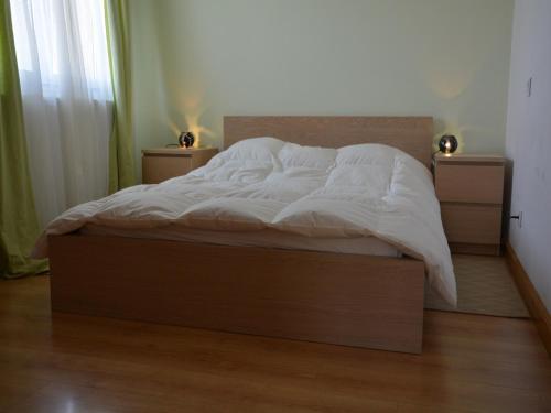 a bed with white sheets and pillows in a bedroom at House in Piquecos with Private Pool & Garden in Piquecos