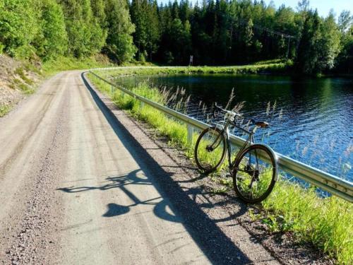 a bike parked on the side of a road next to a river at 4 person holiday home in Ulfborg-By Traum in Fengersfors