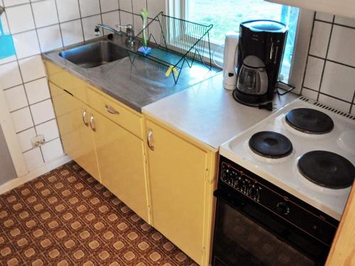 a kitchen with a sink and a stove at 4 person holiday home in Ulfborg-By Traum in Fengersfors