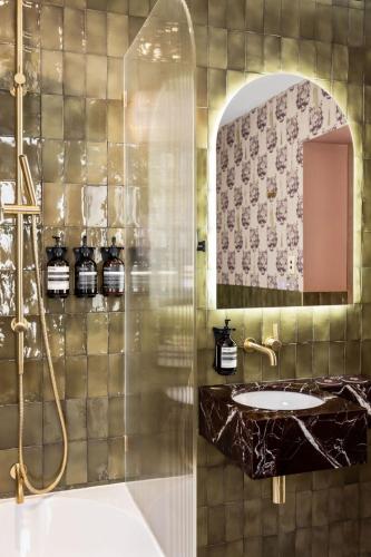 a bathroom with a sink and a shower at Medusa Hotel Sydney in Sydney